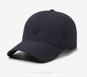 Detail of navy blue baseball cap showing breathable laser-cut holes and embroidered S-shield logo