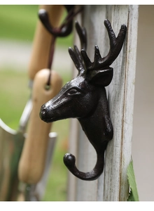 Detailed texture of rustic cast iron deer head wall hook with a vintage bronze finish