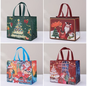Detail view of four Christmas non-woven gift bags with Santa Claus and Reindeer prints