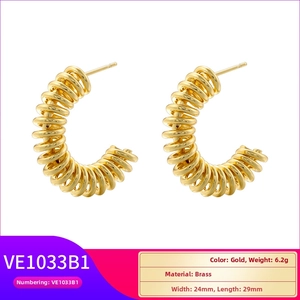 Detail view of 24mm gold brass twist earrings with dimensions and 6.2g weight specs