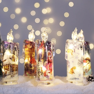 Warm LED Christmas electronic candles with Santa and reindeer prints in a snow setting