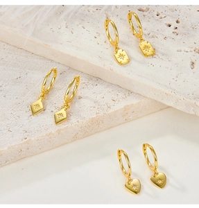 Detailed view of S925 silver gold-plated square, heart and rhombus earrings with zircons