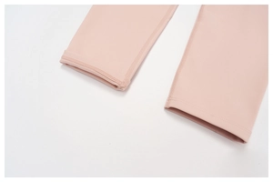 Close-up detail of smooth double-needle stitching on the hem of pink sports leggings