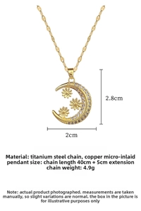 Detail view of crescent moon pendant necklace with flower inlays and sparkling zircon stones