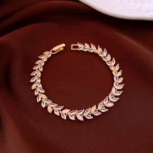 Detailed shot of golden wheat ear bracelet with marquise zircon and cat eye stones