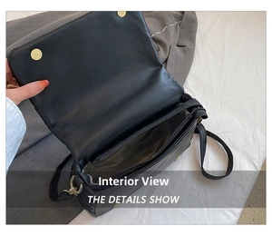 Interior details show of the black quilted shoulder bag with zipper pocket and main compartment