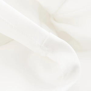 Detailed macro view of white textile fabric texture and premium stitching on a dress