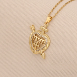 Detailed macro of gold heart pendant with MOM lettering and sparkling cubic zirconia stones