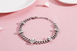 Silver stainless steel chain bracelet featuring five detailed pineapple charms and lobster clasp