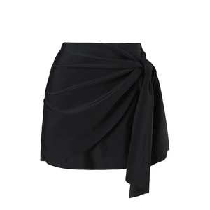 Detail of black high-waisted wrap skirt with tie knot design and draped ruched texture