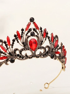 Close-up of black baroque bridal crown with ruby red crystals and alloy metal texture