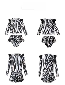 Two-piece girls' swimsuit with black and white zebra print and ruffle sleeve details