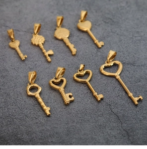 Detailed collection of eight vintage gold heart-shaped key pendants in various styles