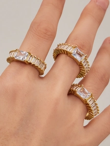 Close-up of three gold-plated micro-pave zircon rings stacked on model's finger