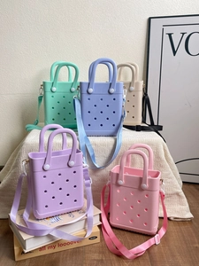 Macro shot of 5 colors EVA beach tote bags with adjustable straps on textured fabric