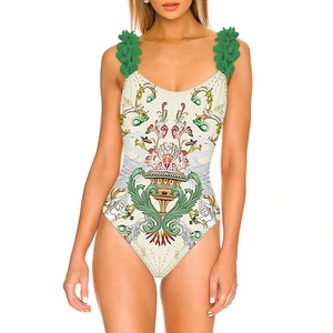Detailed view of Baroque print swimsuit featuring vivid green floral 3D shoulder straps