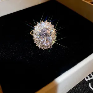 Gold plated oval zircon ring with halo crystals in a luxury black velvet gift box