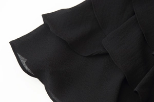 Detail shot of black ruffled layered fabric with fine chiffon texture and hem finishing