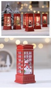 Close-up of red London telephone booth Christmas water lantern with snowman landscape