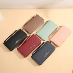 Group of long cross-pattern zip wallets for women with wrist straps in six vibrant colors