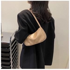 Minimalist beige PU leather shoulder bag shown on model for size and proportion