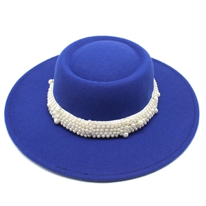 Close-up of royal blue wool felt boater hat with white band and clustered pearl detailing