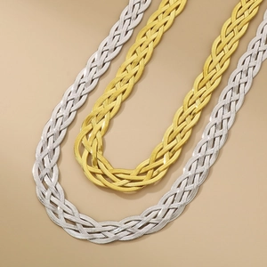Detailed view of woven titanium steel snake chains in gold and silver finishes