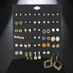 Detailed set of assorted alloy stud earrings with crystals and faux pearls on black card