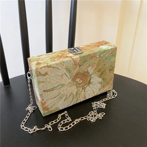 Detail of floral tapestry box bag showing retro sunflower pattern and silver chain