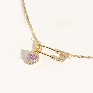 Pink heart zircon pendant necklace with gold safety pin and shimmering micro-set stones
