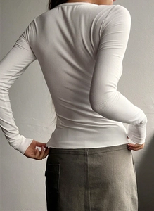 Rear view of white ribbed slim fit long sleeve top showing detailed texture and cut