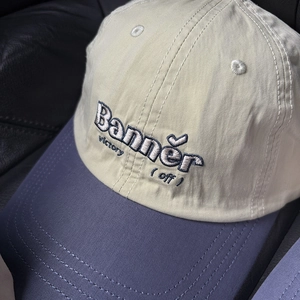 Close-up of Banner embroidery and color-block design on cotton baseball cap detail