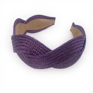 Detail of purple raffia woven headband featuring a stylish crisscross knot design and texture