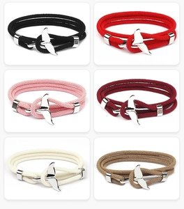 Multiple colors of woven whale tail bracelets with silver metal anchor clasps