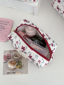 Floral corduroy makeup bag with red zipper and spacious storage for cosmetics