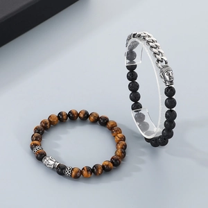 Close-up of tiger eye beads, lava stone, and metal Buddha head on bracelets