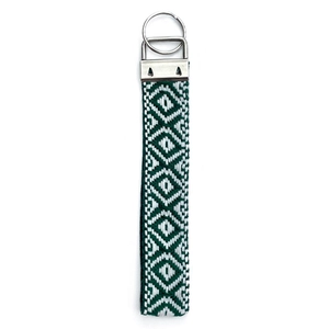 Ethnic woven wristlet keychain with green and white geometric patterns and silver clasp