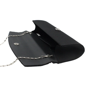 Detail of black satin evening bag with silver magnetic clasp and chain strap