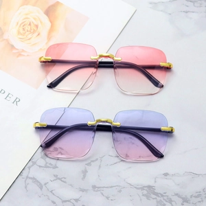 Close-up of rimless diamond-cut sunglasses in pink orange and blue purple gradients