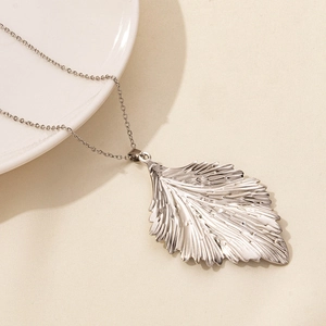 Close-up of leaf pendant necklace with fine texture details and elegant silver chain