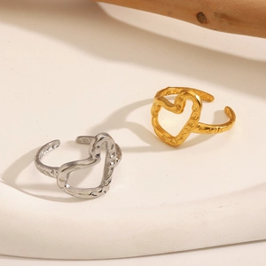 Minimalist heart-shaped open rings in gold and silver with textured hammered finish