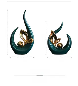 Detailed view of dark green ceramic sculptures with gold spheres and sleek dimensions