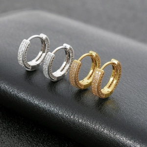 Iced out round hoop earrings in silver and gold plating with micro-pave crystals