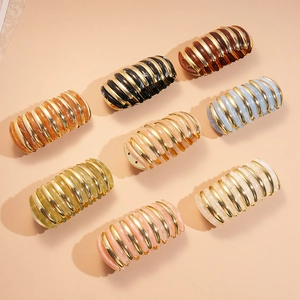 Chic acrylic hair clips with golden stripe accents in diverse colors on beige background