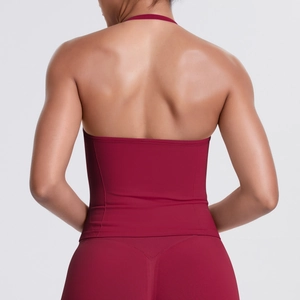 Detail of cross-back design on burgundy high-impact sports bra and yoga pants set