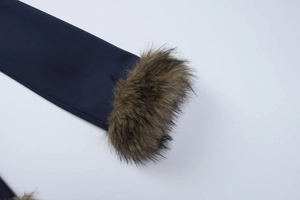 Detailed close-up of dark blue coat cuff featuring plush brown faux fur trim accents