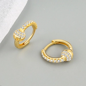 Close-up of gold-plated hoop earrings with micro-pave white zircon stones for women