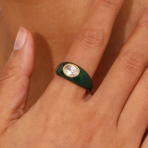Retro 18K gold-plated oval zircon ring with dark green enamel finish on a model's hand