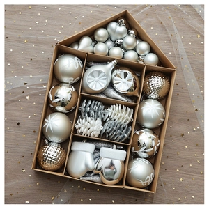 Macro view of Christmas ornaments set in a box with champagne and silver hanging balls