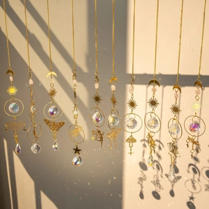 Brass butterfly crystal suncatcher showing golden celestial patterns and shadow effects